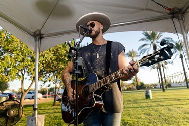 man singing and playing guitar